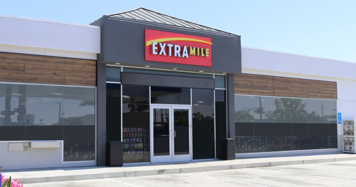 Em Extramile logo